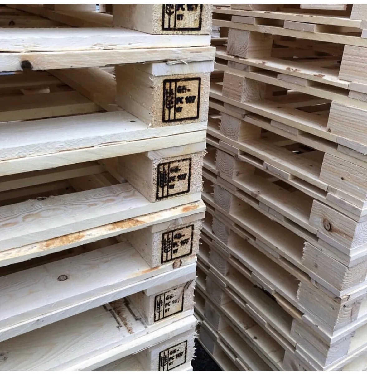 Close view of marked wooden pallets stacked together
