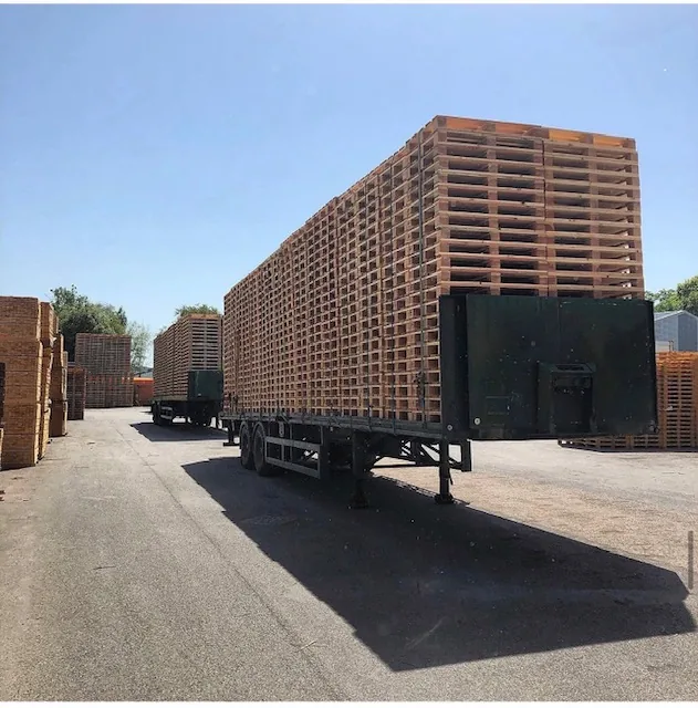 Trailer loaded with wooden pallets in a pallet yard